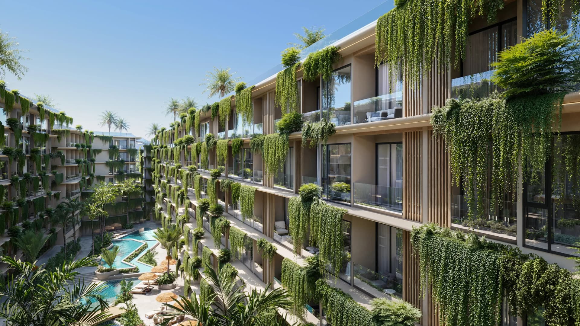 Balconies under cascading plants along the courtyard, pools below